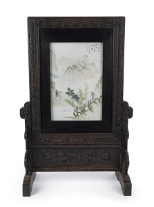 WANG YOUTANG (active 1890-1907), Chinese porcelain table screen in carved wooden stand. The panel decorated with mountain landscape and poem with artist square cartouche in iron red, late Qing Dynasty, 78cm high, 51cm wide, 24cm deep. Note: Illustrated in Qianjiang Ware In The Late Qing Period by Xu-Jinfan and Chen Bing, page 212-229, I.S.B.N. No.978.7.5322.7178.8 A similar example by the same artist sold at Sotheby's New York 17th/18th March, 2015, lot 294.