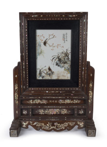 LIU YUCEN (attributed). An exceptional Chinese porcelain panel table screen, adorned with yellow daisies and purple spring flower with poem and verse, signed by the artist in iron red two character cartouche. Attractively mounted in zitan rosewood frame inlaid with mother of pearl which is also signed by the maker, Republic period, early 20th century, 82.5cm high, 56cm wide, 23cm deep