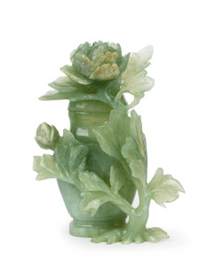 A Chinese carved jade lidded jar decorated with peony flowers and foliage, 19th/20th century, 14.5cm high
