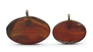 Two antique Islamic calligraphic amulets, carved agate in gold coloured mounts, Ottoman Turkish, ​5.5cm and 4.5cm wide