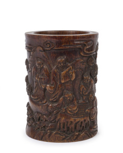 A Chinese carved horn brush pot with scene of Sages in a mountain landscape playing board games, Qing Dynasty 19th century, ​12cm high, 9.5cm wide