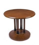 An Austrian circular occasional table, ribbon veneer mahogany with ebonized decoration and turned legs, in the manner of Josef Hoffmann (Wiener Werkstätte), early 20th century, 67cm high, 83cm diameter