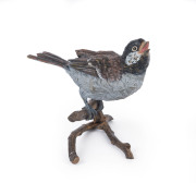 An Austrian cold painted bronze statue of a songbird on a tree branch, early 1900s, 10cm high, 11cm wide