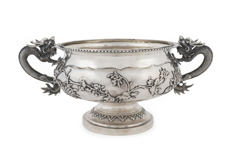 An impressive Chinese silver bowl with embossed floral motif and two finely cast dragon handles, 19th/20th century, ​stamped "CHEONG SHING", 12cm high, 28cm wide, 832 grams