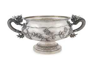 An impressive Chinese silver bowl with embossed floral motif and two finely cast dragon handles, 19th/20th century, stamped "CHEONG SHING", 12cm high, 28cm wide, 832 grams