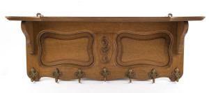 An antique French oak wall mounted coat rack, late 19th century, ​38cm high, 98cm wide, 20cm deep