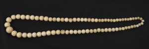 An antique carved whalebone graduated bead necklace, 19th century, 60cm long