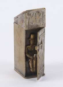 An antique novelty vesta in the form of an outhouse with side door revealing a gentleman in top hat performing his morning ablutions, cast metal with remains of silver plating, 19th century, 5cm high