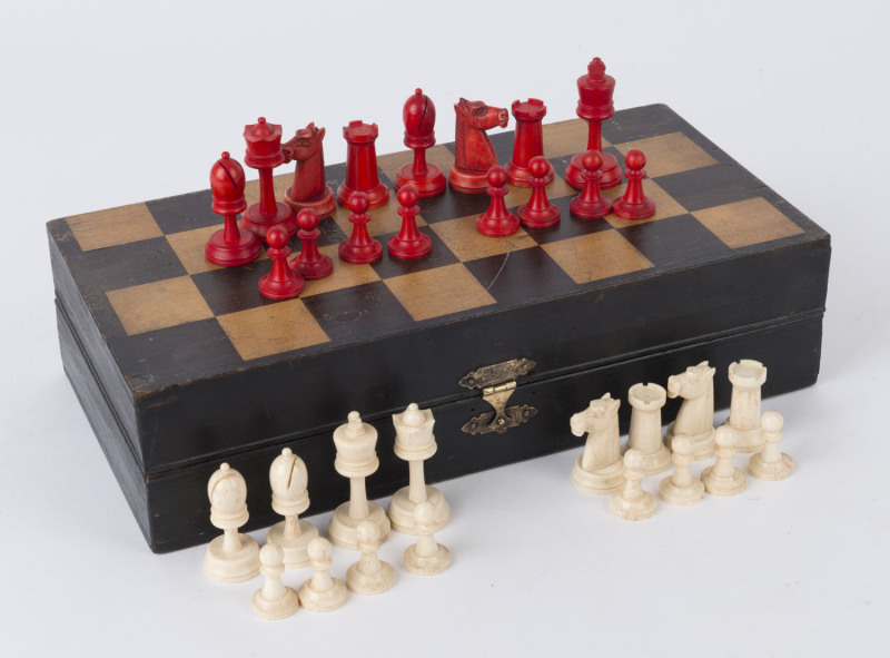 CHESS SET, carved whalebone, housed in original fitted folding games box, early 20th century, ​the box 29.5cm wide