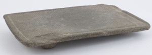 A fine carved greenstone metate, rectangular form with tripod base, west coast Mexico, 650-1000 A.D. 4cm high, 31xcm wide, 20cm deep. PROVENANCE: Dr. Giuliana Zanetti, La Balaustra, Bologna, Italy.