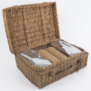 A vintage picnic set comprising wicker cane basket containing two wicker covered bottles and two porcelain and stainless steel cannisters. early 20th century, 42cm wide