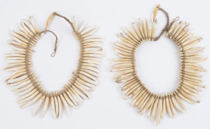 Two pig tooth necklaces with fibre and string bindings, Papua New Guinea, ​51cm and 49cm long