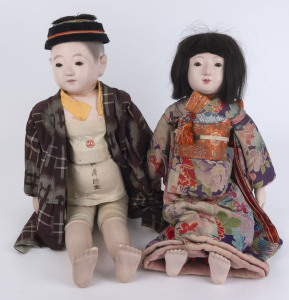 JAPANESE ICHIMATSU DOLLS: male and female dolls in traditional dress with gofun heads, arms and legs, both with inset glass eyes, painted details and hair (on the male figure), the female doll with real hair and wearing floral design kimono, the obi sash 