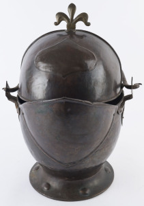 An antique copper and brass coal scuttle in the form of a knight's helmet, circa 1910, 53cm high