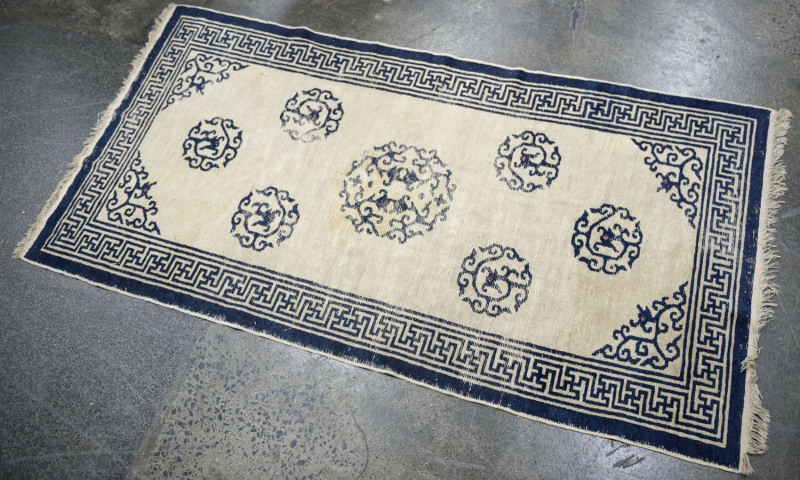 An antique Chinese hand-woven blue wool rug, circa 1920, 185 x 90cm