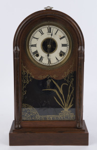 SETH THOMAS American shelf clock, late 19th century. Rosewood veneered arched top with gilt reverse painted glass door, wax card dial and open centre displaying the movement and fretted brass pendulum crutch, 8 day time and gong striking movement with pre