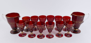 A pair of Murano ruby glass pitchers and 12 matching glasses with gilded highlights, mid 20th century, (14 items), the pitchers 21cm high
