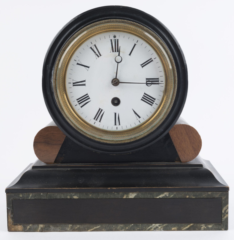 A French time piece mantel clock, late 19th century. Ebonised timber drumhead case and faux marble banded plinth with spring driven 8 day movement, white enamel dial, Breguet style moon hands and decorative cast brass bezel, (with pendulum). 25cm high.