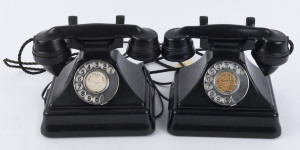 Two black Bakelite vintage telephones with moulded and stepped bases, mid 20th century stamped "Made In England" on the bases. 18cm high,