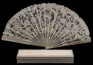 An antique fan, mother of pearl and lace with gilded highlights in original silk lined box bearing Scottish retailer's label, 19th century, the fan 25cm high, 45cm wide