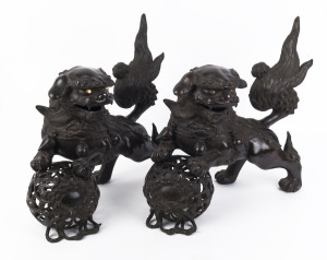 A pair of Chinese bronze foo dog ornaments, 20th century, 41cm high, 53cm long
