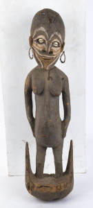 A female figural food hook, carved wood with shell eyes and earrings and earth pigment decoration, Papua New Guinea, ​73cm high