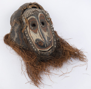 A tribal dance mask, carved wood, woven cane, fibre and shell with earth pigment and clay decoration, Papua New Guinea, ​32cm high, 42cm long