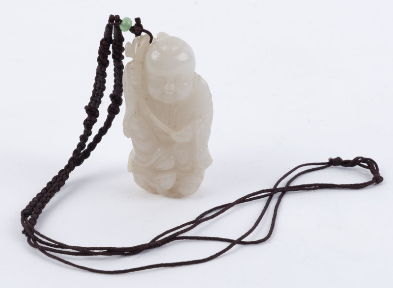 A Chinese mutton jade amulet of a boy holding a Ruyi adorned with four money symbols and a rat at his feet, strung as a necklace on plaited silk, Republic period. Note finely carved facial features, 6.5cm high