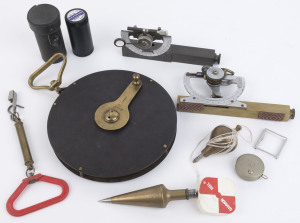 Surveyor's field equipment including, 66 foot field tape by Chesterman of Sheffield, two plumb bobs, two Vernier clinometers (one stamped A.E. Parsons of Melbourne), pocket tape measure and spring balance, (7 items)