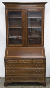 An English Sheridan style bureau bookcase, flame mahogany with satinwood and ebony inlay, Queen Elizabeth II impressed stamp on the back, mid 20th century, interior attractively fitted with drawers, pigeonholes and secret compartments, 223cm high, 119cm wide, 51cm deep