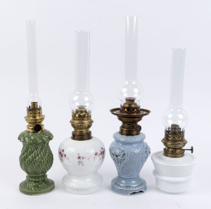Four decorative kerosene lamps, one with moulded white glass font base, the other three with glazed porcelain bases, early 20th century, (4 items), the largest 48cm high