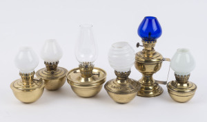 Six small portable brass kerosene lamps, five with weighted dome style bases, all with single brass burners and chimneys, late 19th century, (6 items), the largest 22cm high,