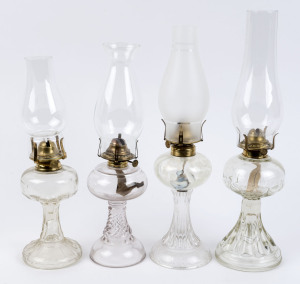 Four moulded clear glass kerosene lamps, early 20th century, (4 items), the largest 43.5cm high,