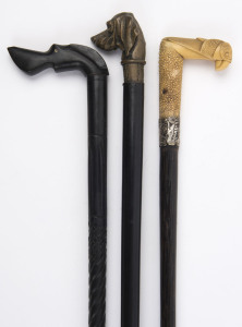 Three antique and vintage walking sticks, two with dog's head handles the other with stylized bird's head, 19th and 20th century, the largest 92cm high