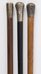 Three antique walking sticks with silver tops, ​the largest 98cm high
