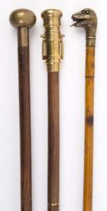 Three walking sticks, one with compass top, one with telescope top, the other with snake's head, 20th century, the largest 97cm high