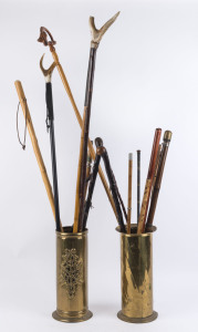 Fifteen assorted walking and hiking sticks housed in two brass stick stands, 19th and 20th century, (17 items), ​the largest 115cm high