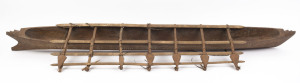 A large model outrigger canoe, carved wood and natural fibre with remains of piped clay, Samoa, mid 20th century, ​167cm long
