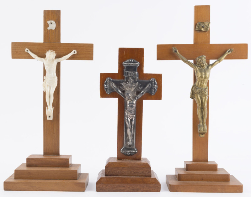 Three assorted free standing crucifix statues, 20th century, ​the largest 36cm high