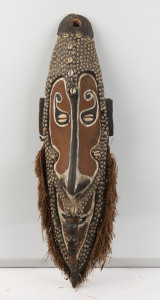 A spirit mask, carved wood, shell and fibre beard with earth pigments, Papua New Guinea, 75cm high