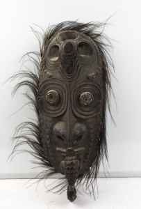 A spirit mask, carved wood, feather and shell with earth pigments, Kandingai Village, Middle Sepik, Papua New Guinea, ​68cm high