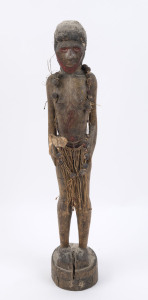 A standing female figure, carved wood, hair and fibre with red painted face and seed bead adornment, Papua New Guinea, ​59cm high