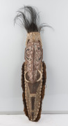 An ancestral spirit mask, carved wood, feather, fibre, tusk, shell, clay and earth pigments, Papua New Guinea, ​95cm high