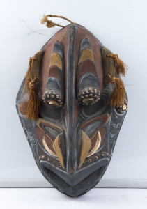 An ancestral spirit mask, carved wood, tusk, shell and fibre with earth pigment decoration, Papua New Guinea, ​55cm high