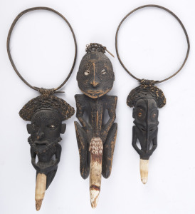 Three figural necklaces, carved wood, tooth, shell, cane and fibre with painted finish, Maprik area, Papua New Guinea, the largest 34cm high