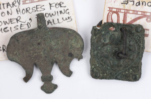 Two Roman bronze artefacts comprising a Phallerae amulet and a belt plate, Roman Britain, 2nd to 3rd century A.D. With CofA from Halcyon Antiques and Antiquities, Newcastle, Australia. 4.5cm and 3.5cm wide