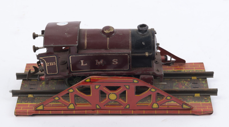 HORNBY TRAINS: 'O'-gauge London Midland Scottish (LMS 2115) 0-4-0 clockwork (no key) locomotive, c.1930s; plus a section of Mettoy 'O'-gauge girder bridge track; locomotive length 19cm, track length 26cm.