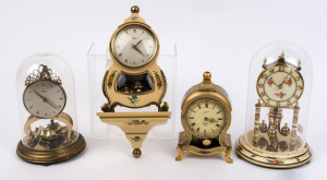 Two German 400 day anniversary clocks, together with two miniature Neuchatel style clocks, one by Schatz with a cream and floral painted case and matching wall bracket with 400 day movement; the other by Schmid in a gilt and floral decorated case with an 