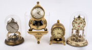 Two German 400 day anniversary clocks, together with two miniature Neuchatel style clocks, one by Schatz with a cream and floral painted case and matching wall bracket with 400 day movement; the other by Schmid in a gilt and floral decorated case with an