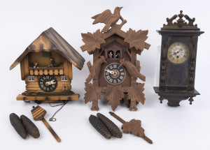Two German Black Forest cuckoo clocks, 20th century. Both clocks with caved timber cases and 30 hour weight driven twin bellow movements. One clock with cuckoo and huntsman hour and half hour automata, the other with single cuckoo and two huntsmen sawing 